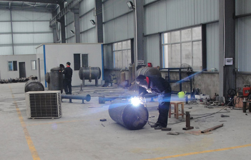 Skilled workers are working on cast iron pressure tanks